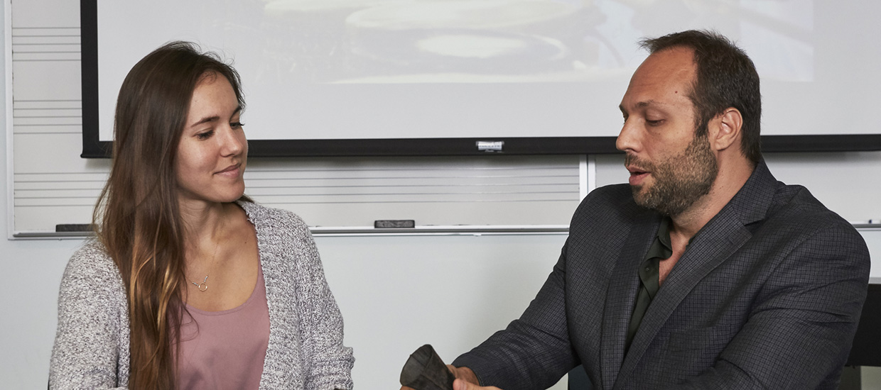 Professor and Student examining a musical instrument