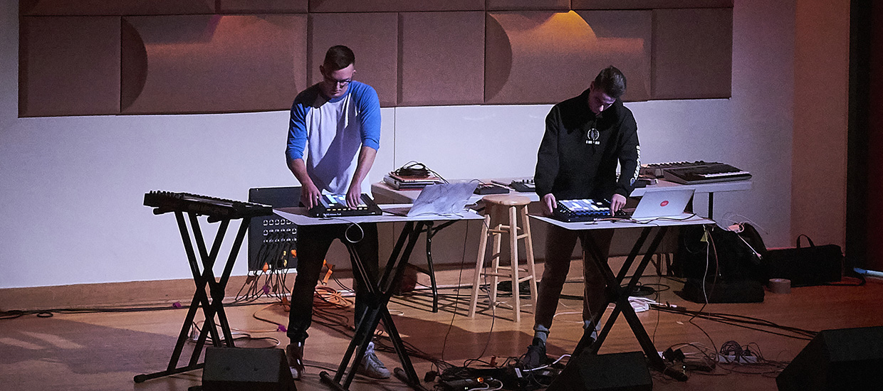 Duo performs live on stage with drum machiens
