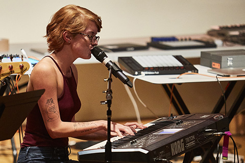 Artist singing while playing the piano